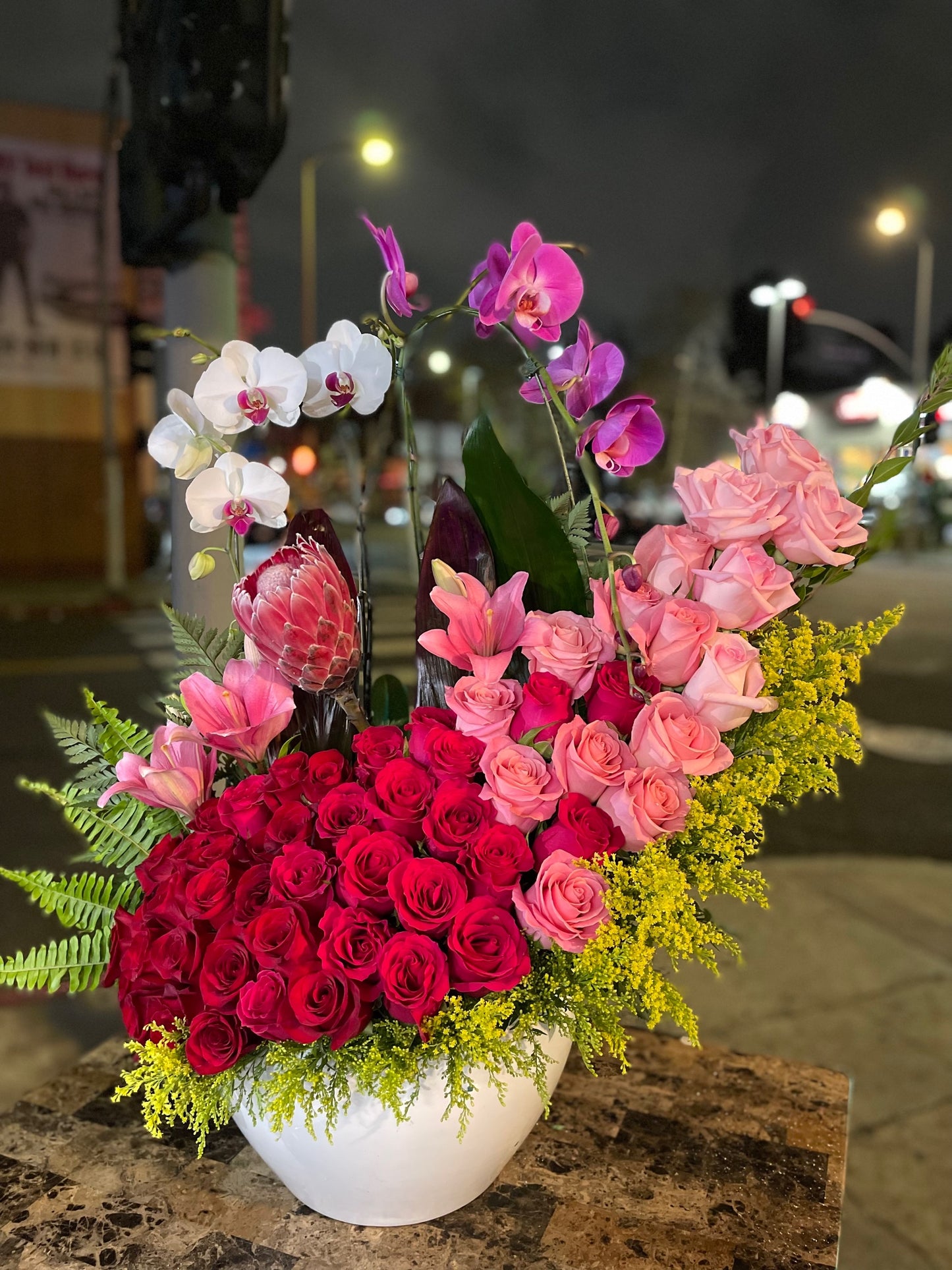Beautiful Red and Light Pink Hermosa Roses with 2 Orchids in large ceramic vase image 0
